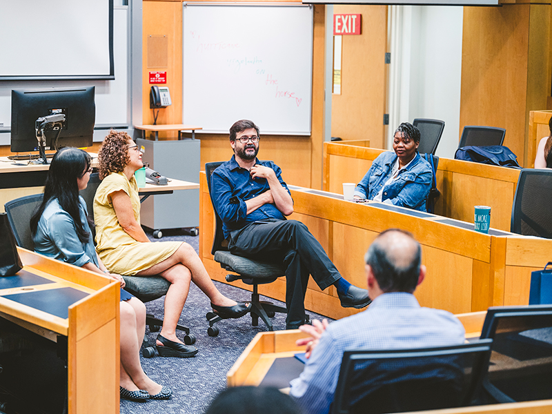 Faculty members talking in a classroom