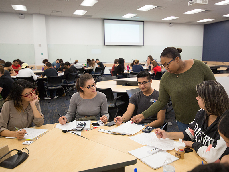 Faculty member helping a group of students