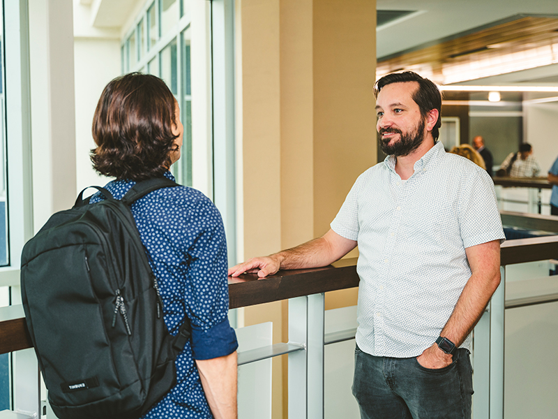 Faculty member speaking to a student